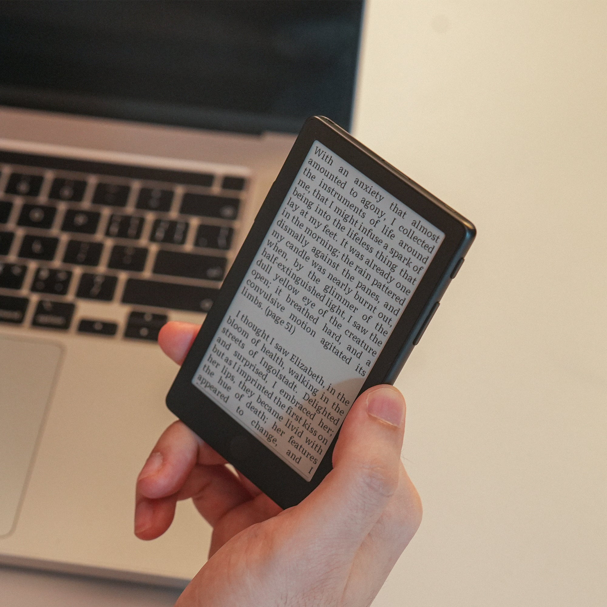 XTEINK X4 Pro displaying a book beside a laptop